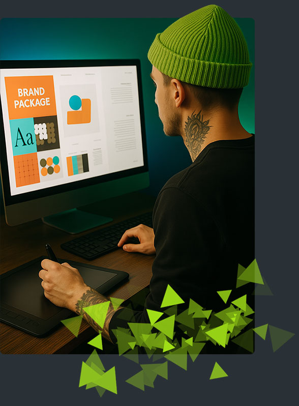 our-work-header-p1b designer at desk working on branding with green cap on his head
